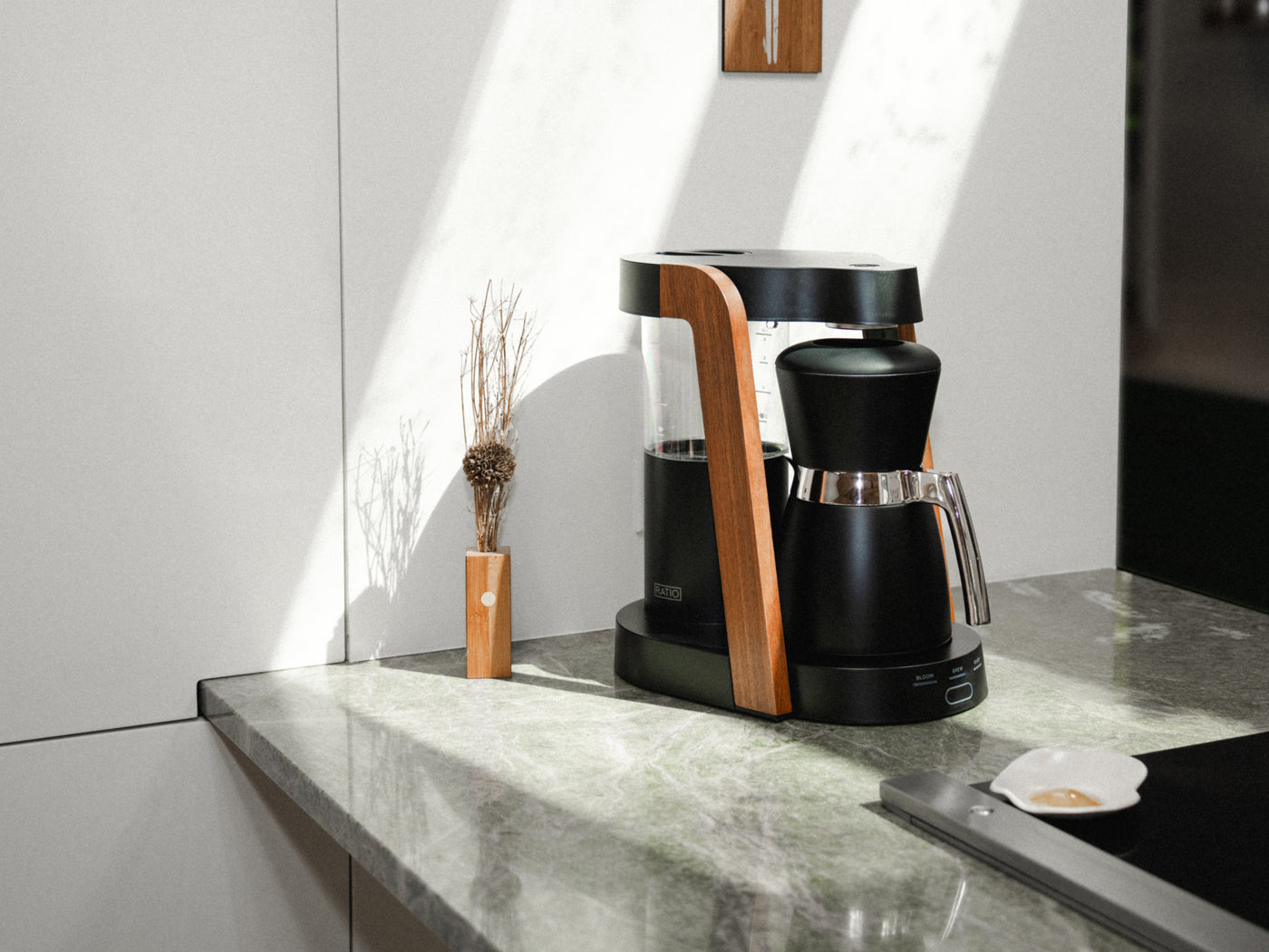 Ratio coffee machine with wood detailing in a sunlit kitchen.